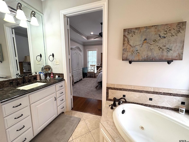 bathroom featuring vanity, tiled bath, tile patterned floors, and crown molding