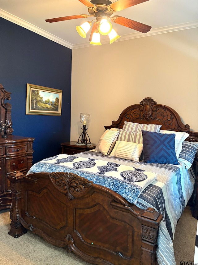 carpeted bedroom with ceiling fan and ornamental molding