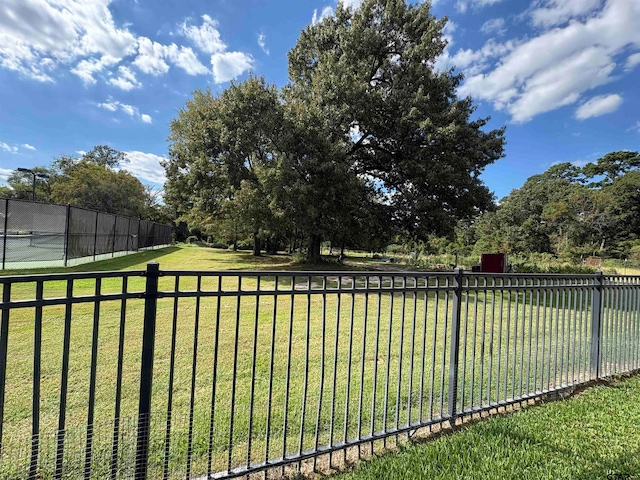 view of yard featuring tennis court