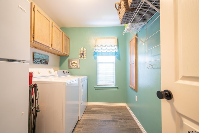 laundry area with cabinet space, washing machine and dryer, dark wood-style floors, and baseboards