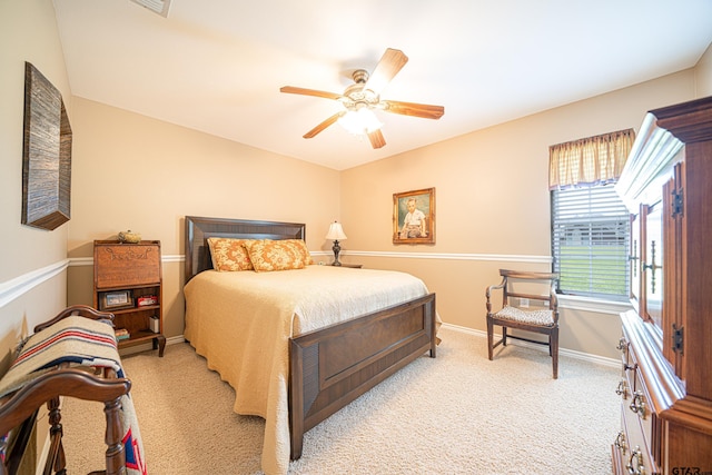 bedroom featuring a ceiling fan, light carpet, and baseboards