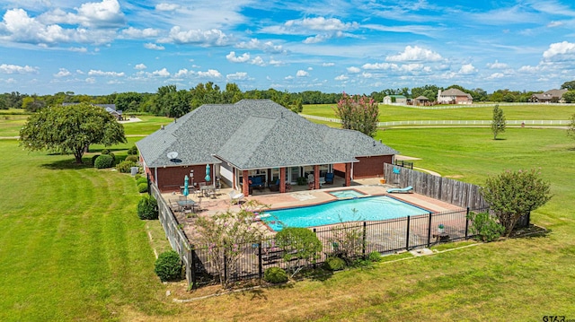 view of swimming pool with a fenced backyard, a patio, and a lawn