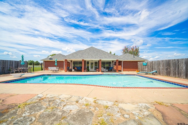 view of swimming pool with a fenced in pool, a patio area, fence, and a diving board