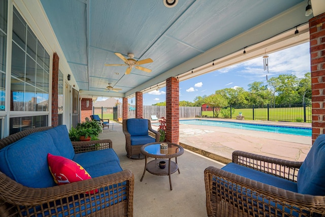 view of patio / terrace with an outdoor living space, a fenced backyard, a fenced in pool, and a ceiling fan