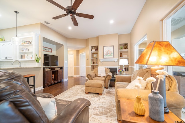 living area with visible vents, a ceiling fan, dark wood-style flooring, a fireplace, and recessed lighting