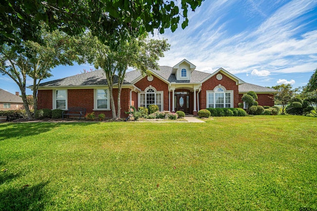 view of front of home featuring a front yard and brick siding