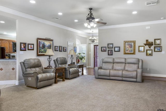 living room featuring ornamental molding, light carpet, and ceiling fan