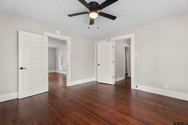 interior space with baseboards, a ceiling fan, and wood finished floors