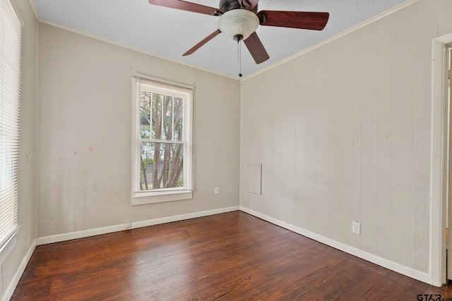 empty room with baseboards, ceiling fan, and wood finished floors