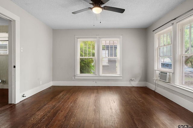 spare room with wood-type flooring, a textured ceiling, and plenty of natural light