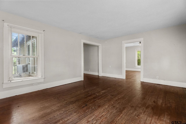 unfurnished room with baseboards and hardwood / wood-style floors