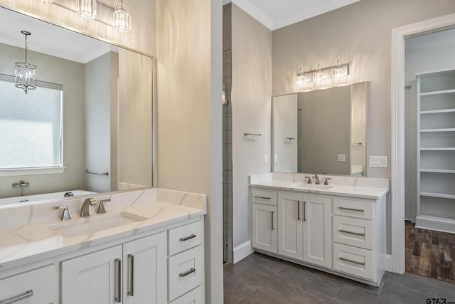 bathroom with hardwood / wood-style floors, vanity, crown molding, and an inviting chandelier