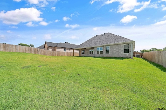 rear view of house with a lawn