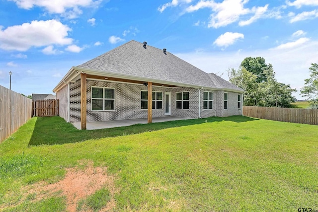 back of property featuring a patio and a lawn