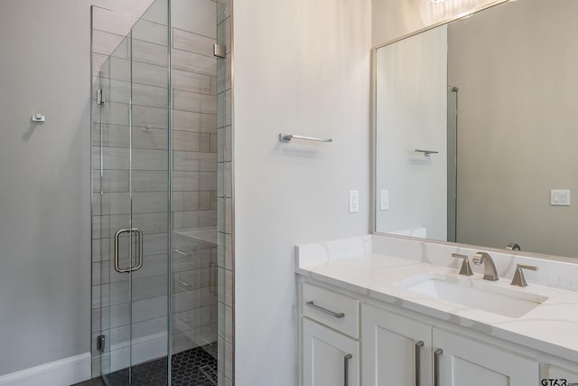 bathroom with vanity and a shower with shower door