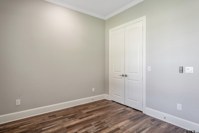 unfurnished bedroom featuring dark hardwood / wood-style floors and crown molding