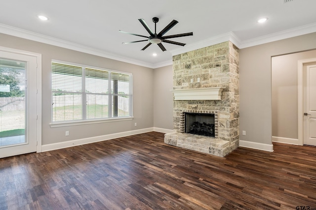 unfurnished living room featuring dark hardwood / wood-style flooring, ceiling fan, a stone fireplace, and ornamental molding