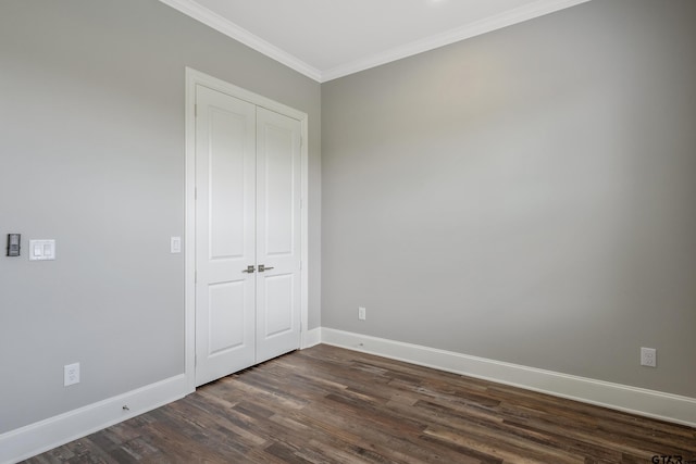 unfurnished bedroom with dark hardwood / wood-style flooring and crown molding