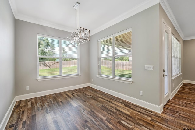 unfurnished room with a notable chandelier, dark hardwood / wood-style floors, and crown molding