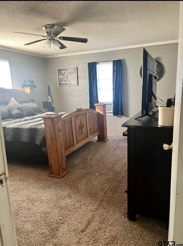 bedroom with ceiling fan, a textured ceiling, and carpet floors