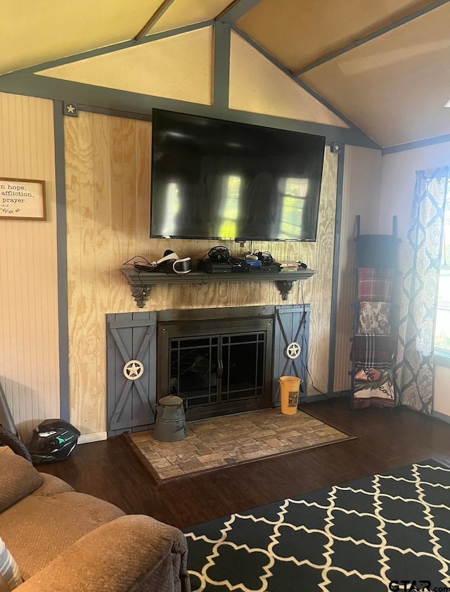 living room with dark hardwood / wood-style flooring, lofted ceiling, and wooden walls