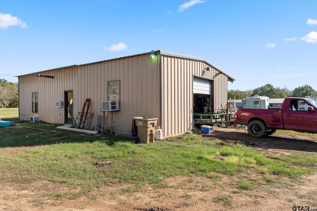 view of outdoor structure featuring cooling unit and a garage