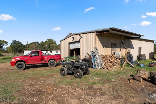 view of outbuilding with a garage and cooling unit