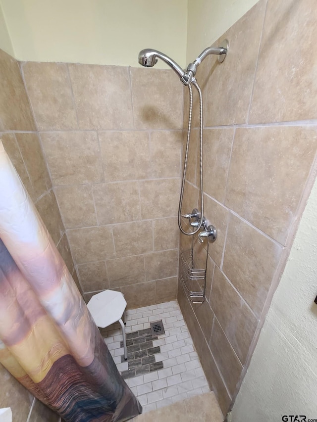 full bathroom with tiled shower