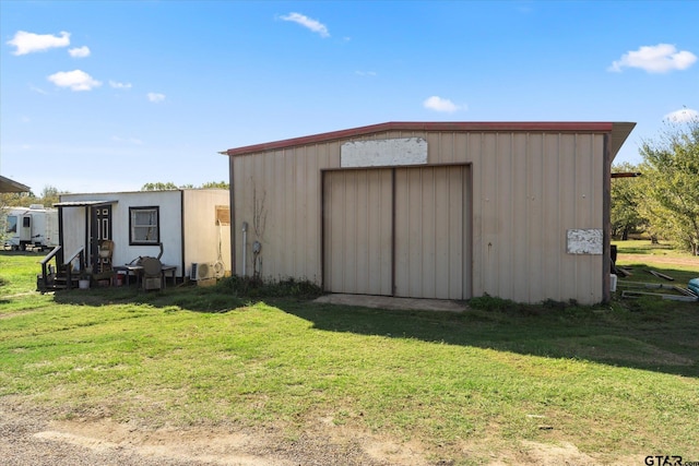 view of outdoor structure featuring a lawn