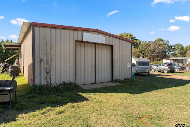 view of outbuilding featuring a lawn