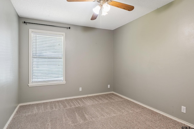 spare room with carpet flooring, a textured ceiling, and ceiling fan