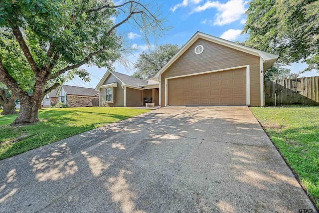 view of front of property featuring a garage and a front yard