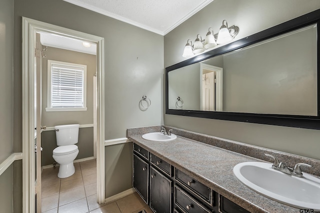 bathroom featuring tile patterned floors, crown molding, vanity, a textured ceiling, and toilet