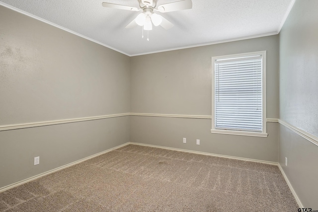 carpeted spare room featuring ceiling fan, a textured ceiling, and ornamental molding