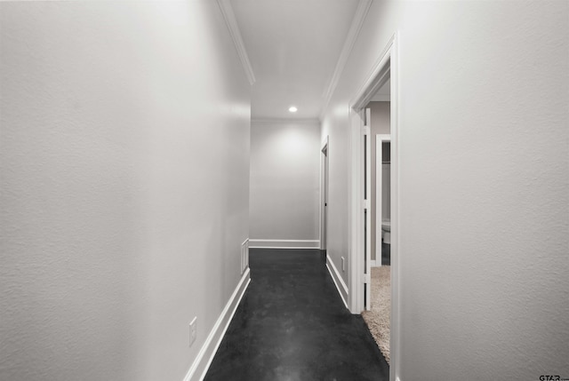 hall with dark carpet and crown molding