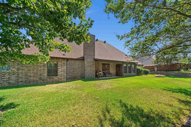 back of house featuring a yard