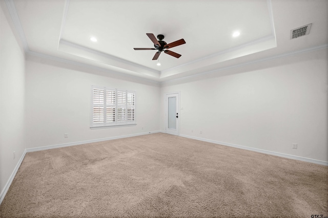 unfurnished room featuring carpet, ceiling fan, a raised ceiling, and ornamental molding