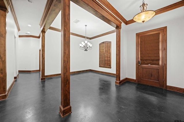 foyer entrance featuring ornate columns, crown molding, and an inviting chandelier