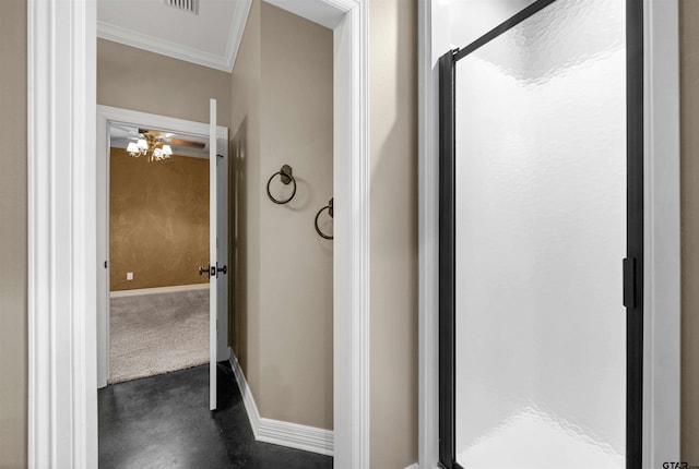 bathroom with an enclosed shower and crown molding