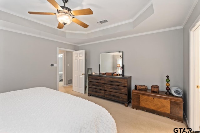 bedroom featuring ornamental molding, light colored carpet, ceiling fan, and a raised ceiling