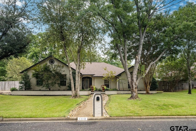 single story home with a front yard