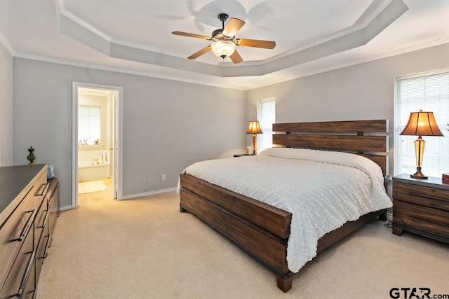 carpeted bedroom featuring ceiling fan, multiple windows, and a raised ceiling