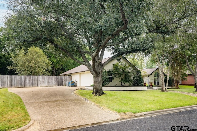 view of front of property with a garage and a front lawn