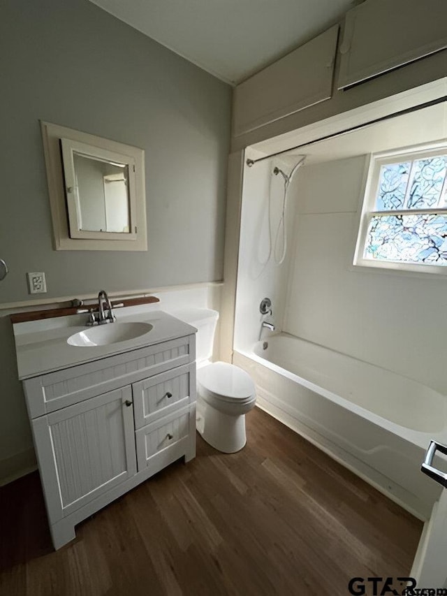 full bathroom featuring shower / tub combination, hardwood / wood-style flooring, vanity, and toilet