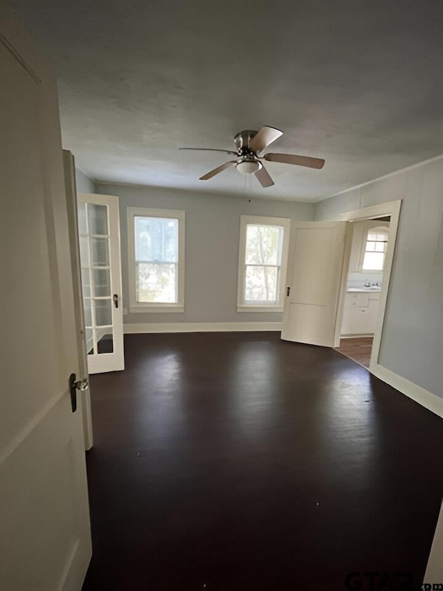 spare room with ceiling fan and dark wood-type flooring