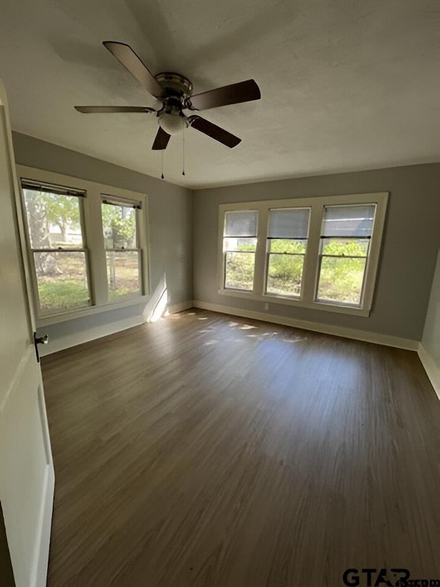 unfurnished room featuring dark hardwood / wood-style floors and ceiling fan