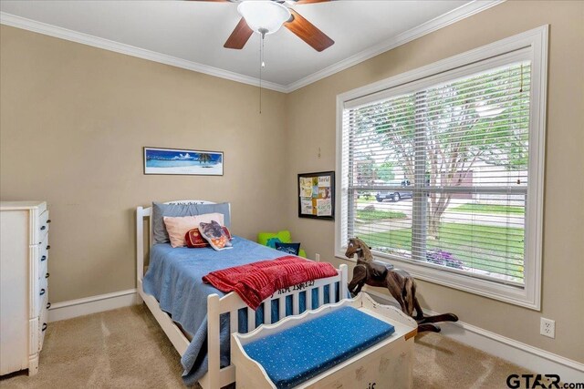 bedroom featuring light colored carpet, ceiling fan, and ornamental molding