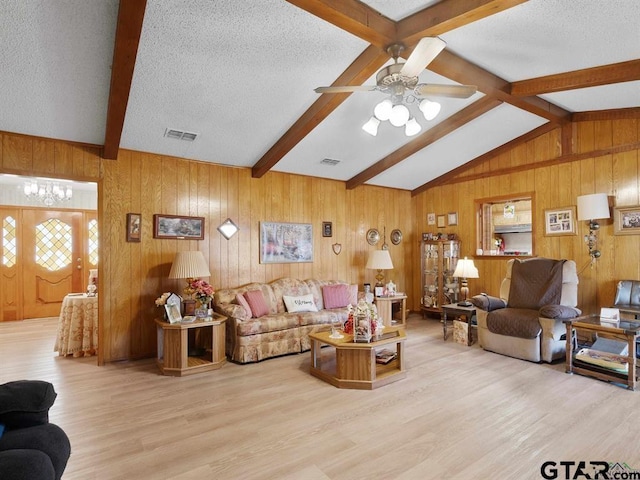 564 County Road 1100, Daingerfield, TX 75638 - living room with wood finished floors, wooden walls, a textured ceiling, and a ceiling fan