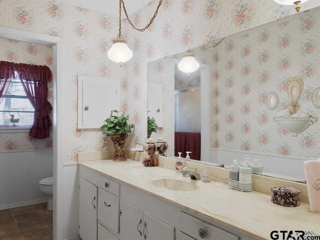 564 County Road 1100, Daingerfield, TX 75638 - bathroom featuring vanity, wallpapered walls, toilet, a stall shower, and tile patterned flooring