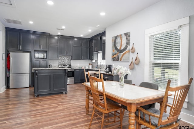 dining room with light hardwood / wood-style floors and sink